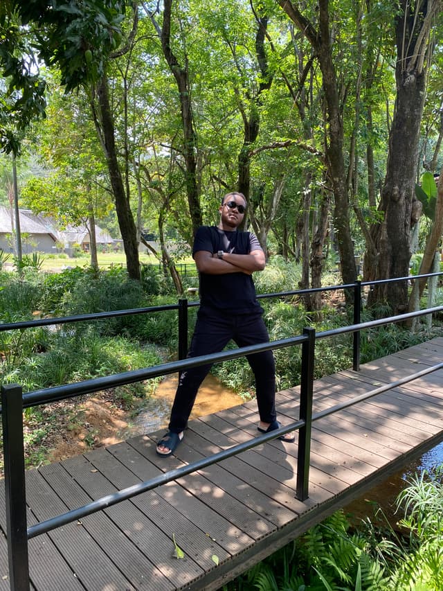 An image of Lesedi Molemi posing in the woods